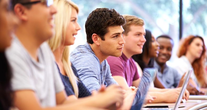 Students sitting at desks in a lecture room.